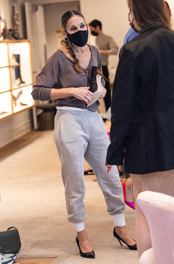 Sarah Jessica Parker wears Pangaia cuffed track pants and SJP Hello Lover pumps at her South Street Seaport shoe store in New York City on January 17, 2021