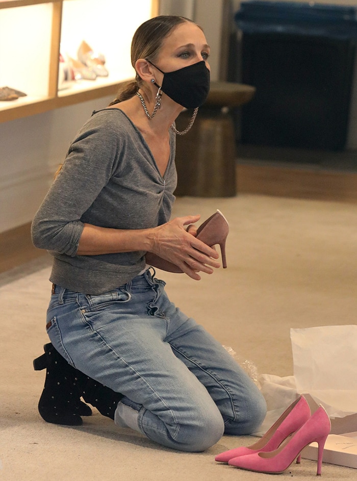 Sarah Jessica Parker works inside her South Street Seaport SJP Collection shoe boutique wearing black studded Busker boots