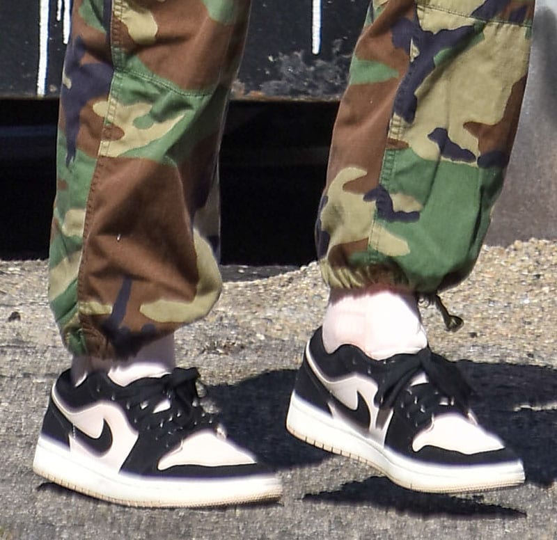 A closer look at Addison Rae's Nike Air Jordan 1 Low "Black Guava Ice" sneakers, featuring soft Guava Ice leather panels contrasted by black overlays, Swooshes, and laces—a women's-exclusive colorway that became one of the most sought-after Jordan releases of 2020