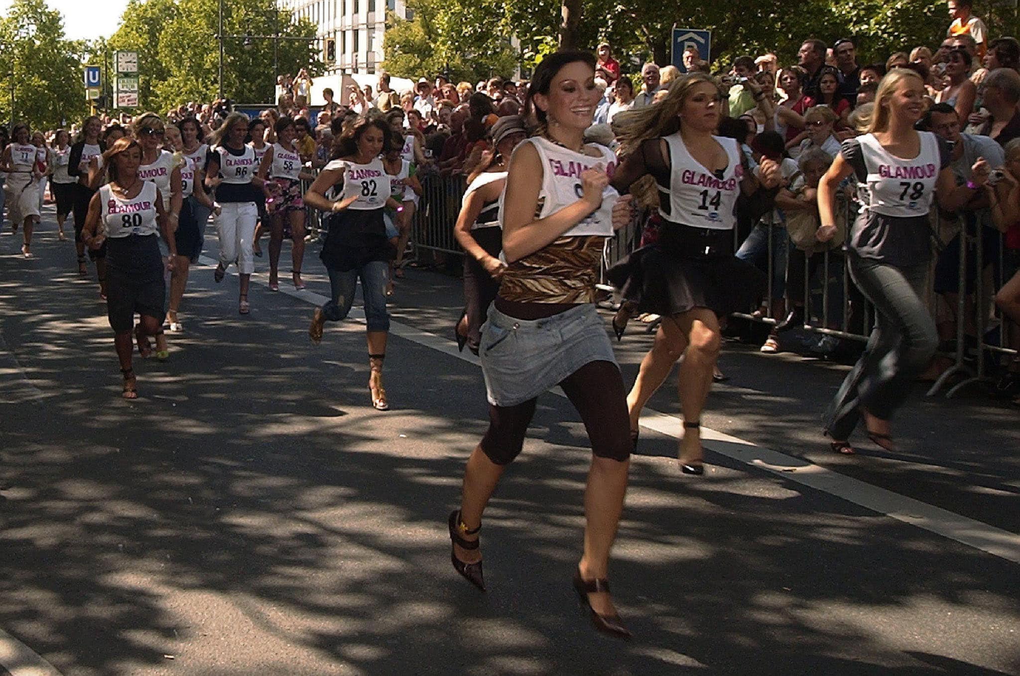 Women sprint in stilettos during a high-heel race organized by Glamour magazine in Berlin, Germany, drawing a crowd of spectators in 2006