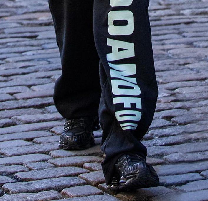 Bella Hadid slips into a pair of all-black Nike Shox sneakers, known for their signature shock-absorbing columns that provide both style and high-performance cushioning