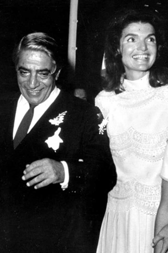 Jackie Kennedy marries Greek shipping magnate Aristotle Onassis in 1968, wearing a white Valentino wedding dress that cemented the house’s place in couture history
