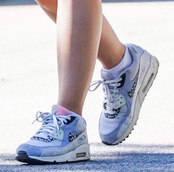 A closer look at Lucy Hale's Nike Air Max 90 sneakers, whose visible Air cushioning and classic running-inspired silhouette complement her sporty hiking outfit
