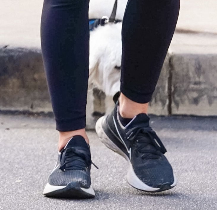 A closer look at Lucy Hale's black Nike Renew Run sneakers, featuring a breathable mesh upper, lightweight cushioning, and a durable rubber outsole for everyday walks and light hikes