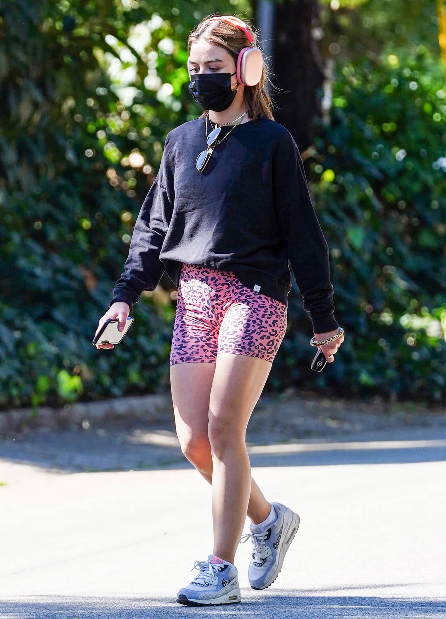 Lucy Hale pairs pink leopard-print Aura 7 Activewear cycling shorts with Nike Air Max 90 sneakers for a solo hike