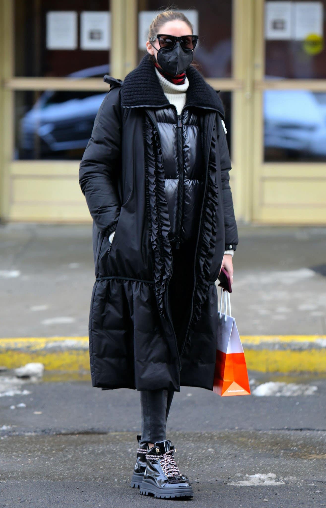 Olivia Palermo bundles up in a Moncler Genius x Simone Rocha coat, a vinyl jacket, and a cream knit sweater