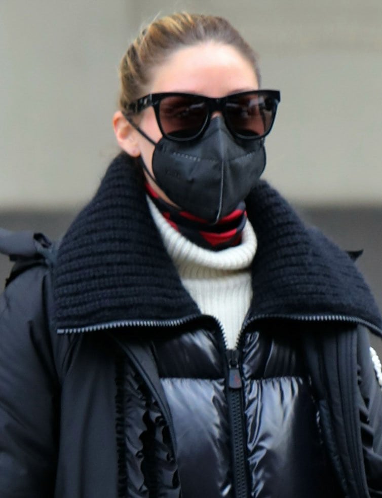 Olivia Palermo scrapes her hair back and accessorizes with tortoiseshell sunnies and a black face mask
