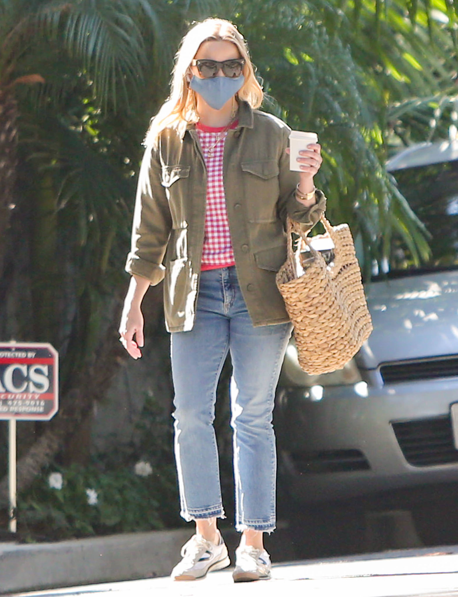 Reese Witherspoon steps out in Los Angeles wearing a relaxed errand-day look anchored by classic white Tretorn sneakers, balancing comfort and polish