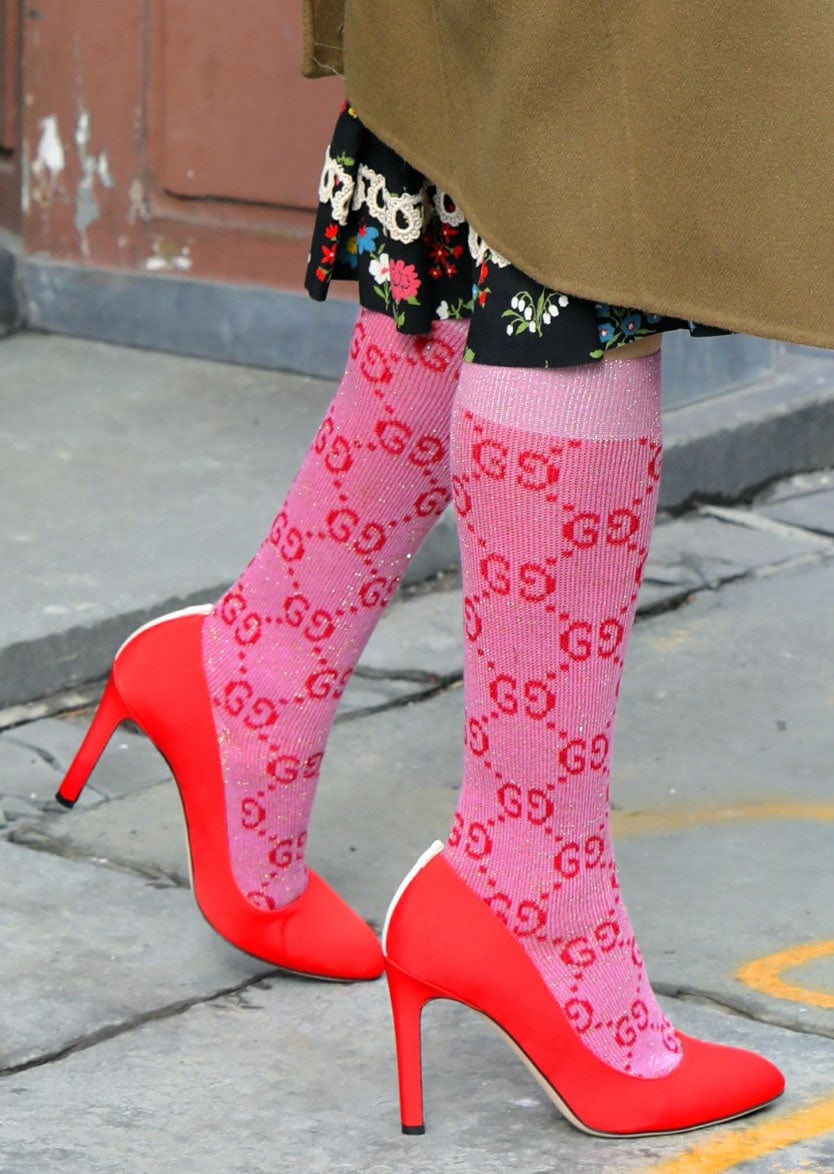 Sarah Jessica Parker wears pink Gucci GG knee-high socks with red SJP Fawn pumps featuring 4-inch stiletto heels and white grosgrain trim