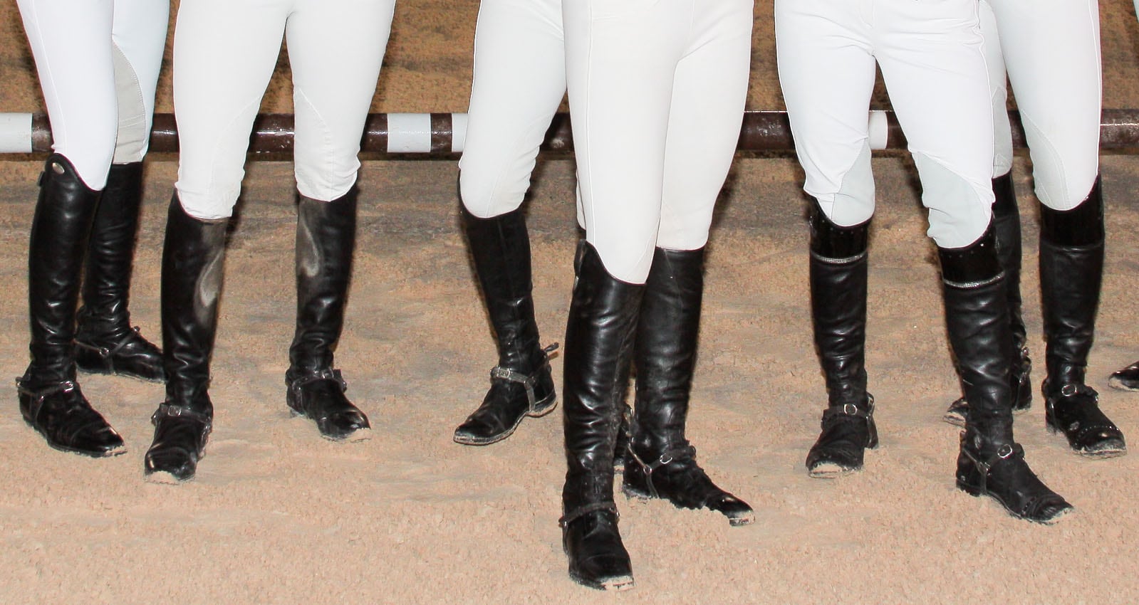 Traditional black equestrian boots paired with white breeches showcase the timeless riding uniform