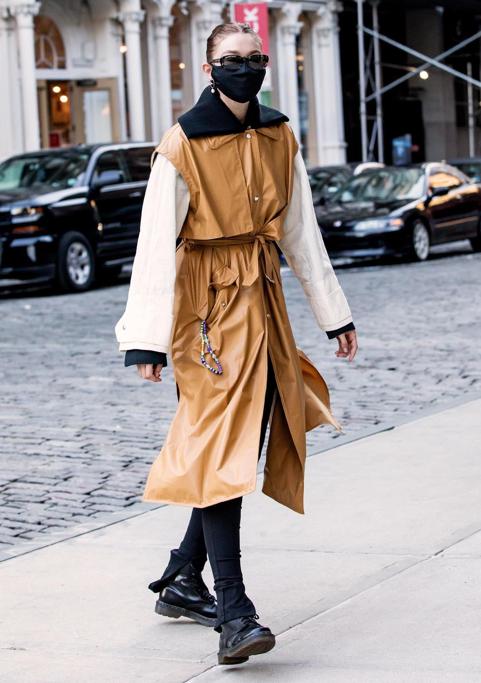 Gigi Hadid keeps her outfit simple as she teams her eye-catching coat with black leggings