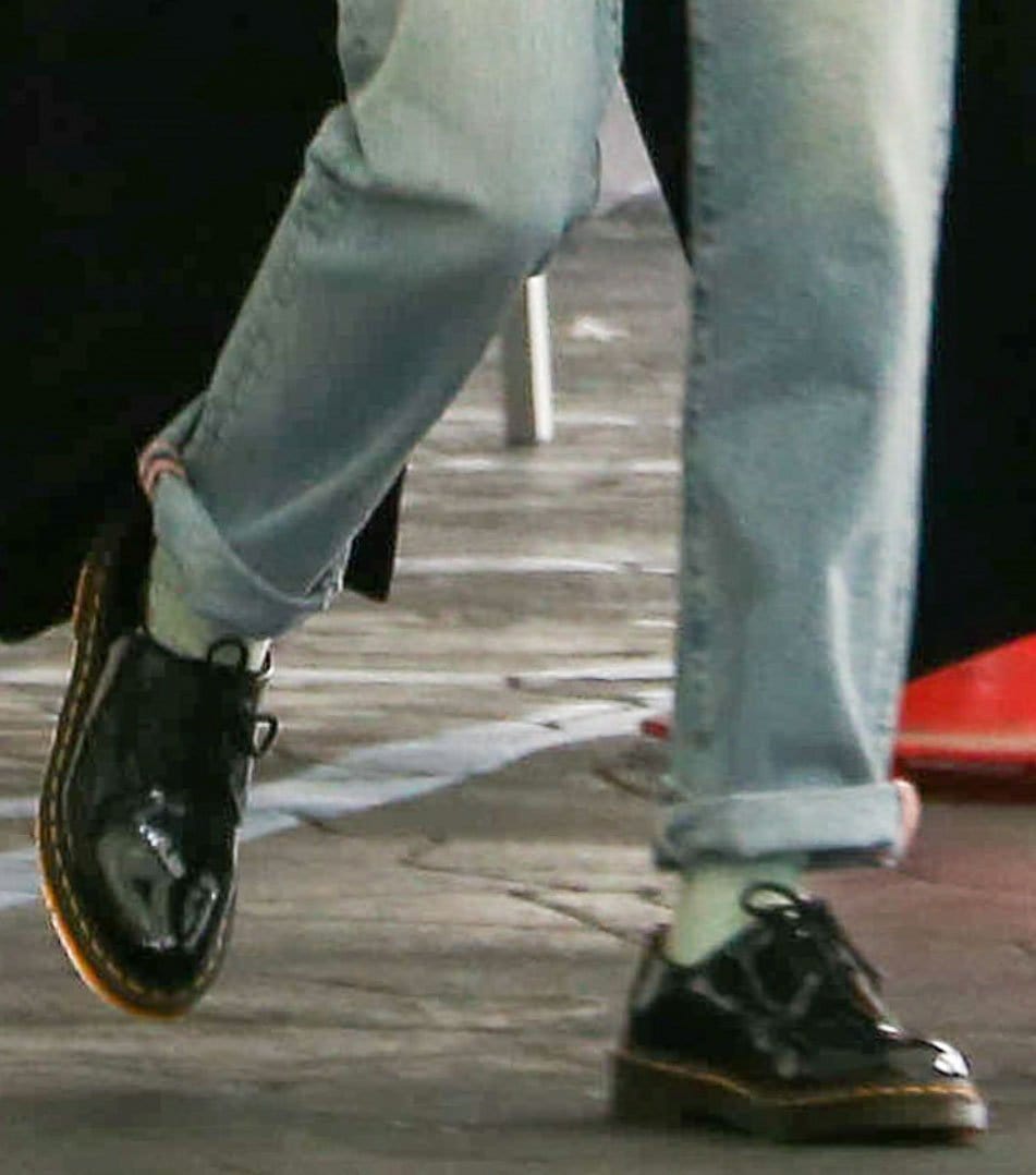 The high-shine patent finish and classic three-eye construction make Hailey Bieber's Dr. Martens 1461 oxfords the standout element of her street-style ensemble
