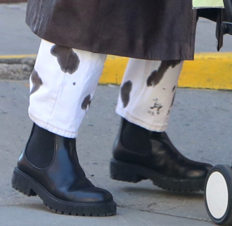 A closer look at Irina Shayk’s black leather Ferragamo Varsi Chelsea boots, featuring elastic side panels, chunky block heels, platformed lug soles, and embossed branding