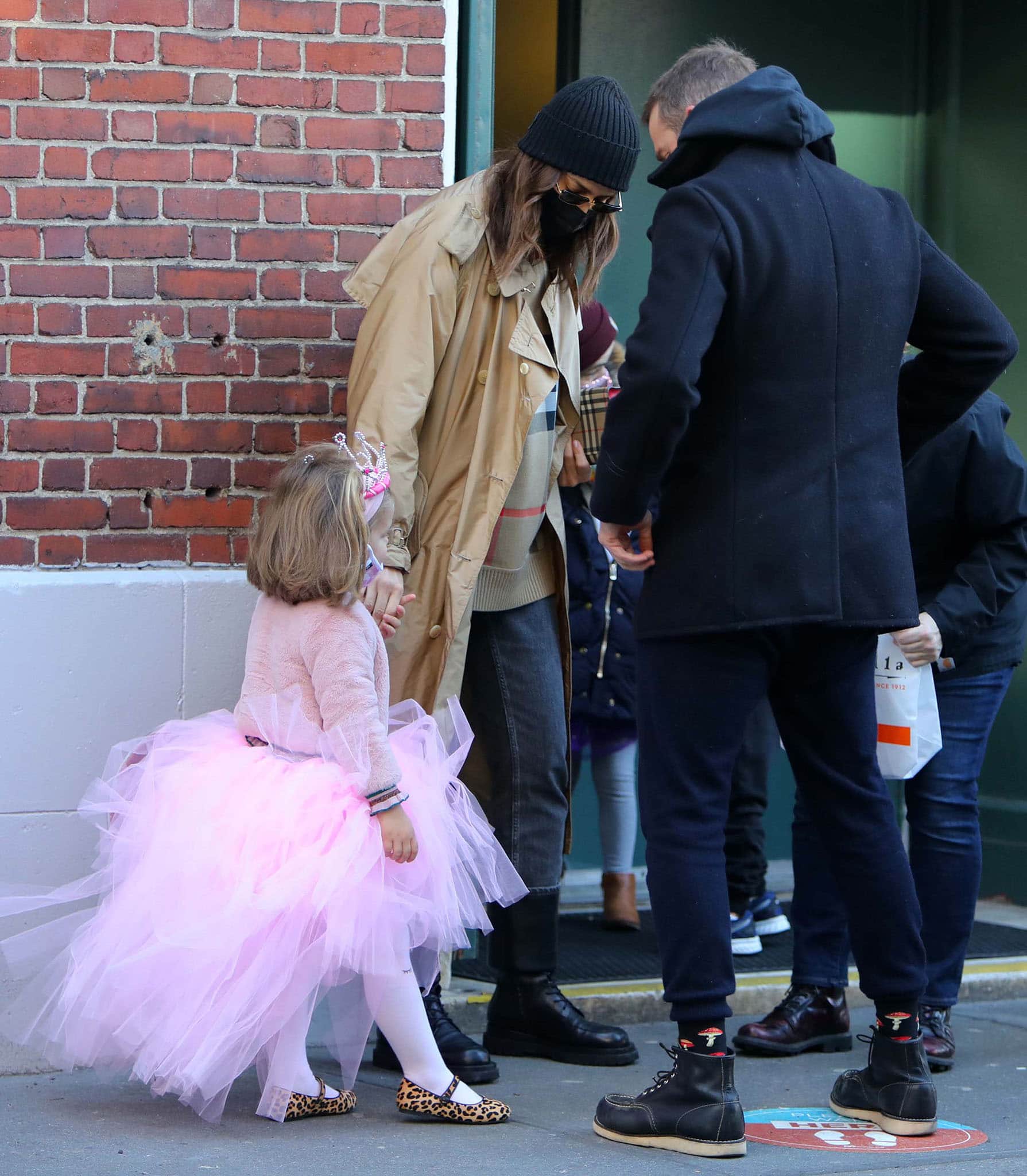 Irina Shayk and Bradley Cooper reunite for a SoHo school run with daughter Lea De Seine, whose pink tutu and leopard-print flats add a playful contrast to her parents’ dark, practical footwear