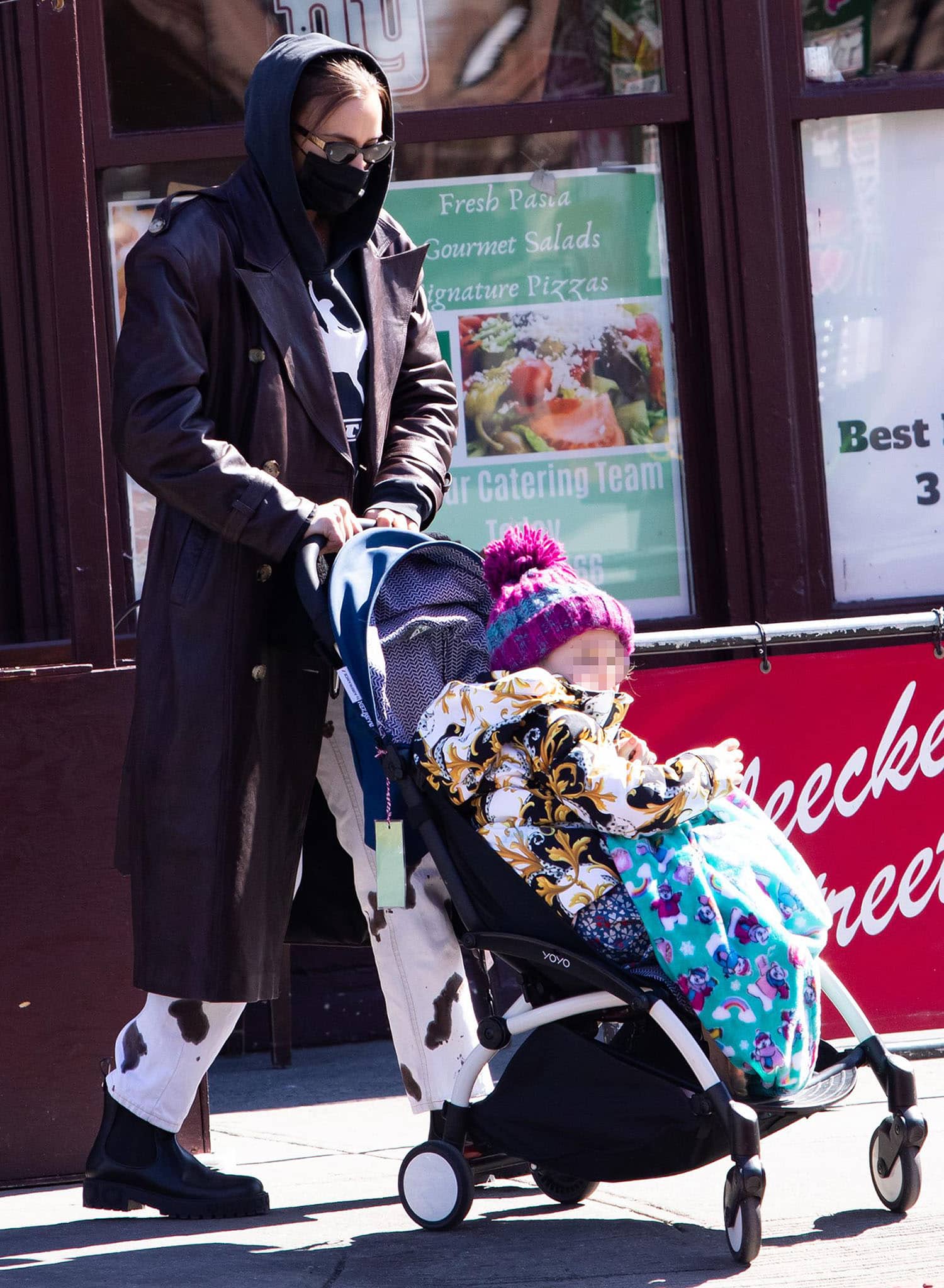 Irina Shayk wears chunky black Salvatore Ferragamo Varsi Chelsea boots while pushing daughter Lea De Seine in a stroller in New York City
