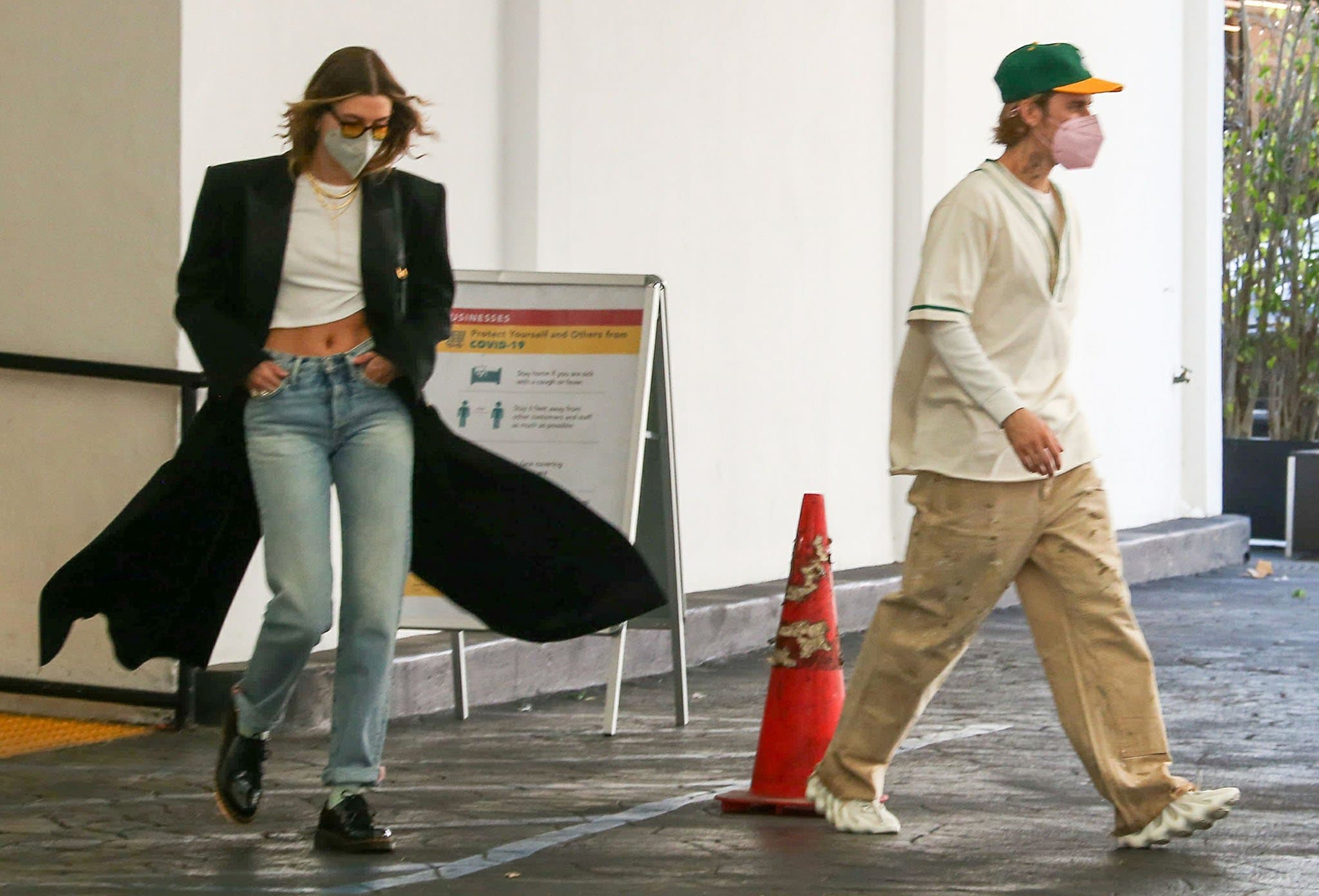 Hailey Bieber balances polished tailoring and casual denim while Justin Bieber steps out in the sculptural Adidas Yeezy 450 Cloud White sneakers outside a Beverly Hills skincare clinic