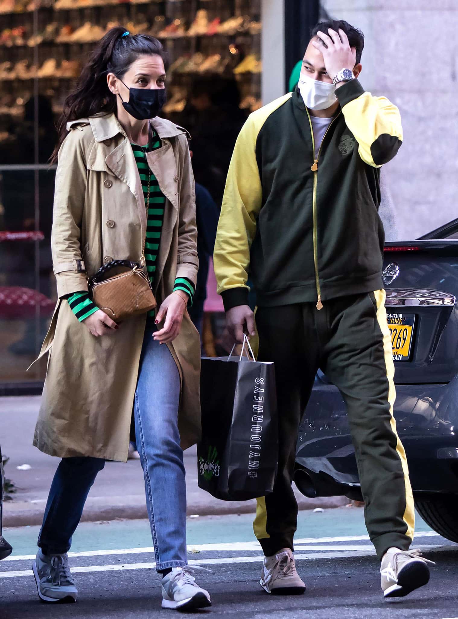 Katie Holmes masters effortless New York street style, pairing retro Saucony Jazz 81 sneakers with relaxed jeans and a classic camel trench while stepping out with Emilio Vitolo Jr. in Manhattan