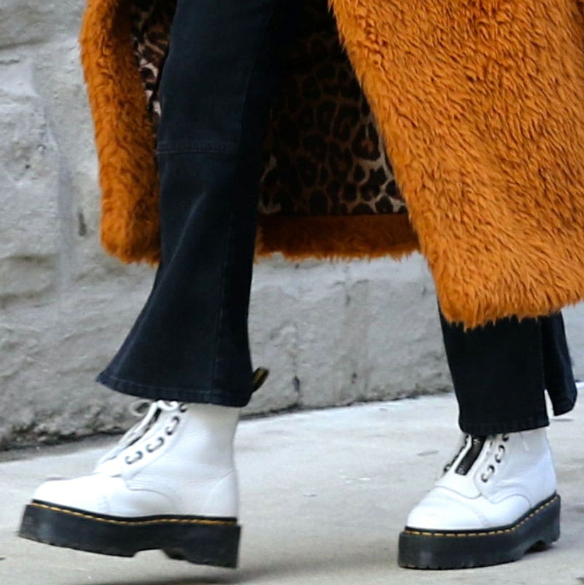 The Dr. Martens Sinclair boots anchor the outfit with their chunky Quad sole and front-zip design, adding height and edge without overpowering the streamlined base