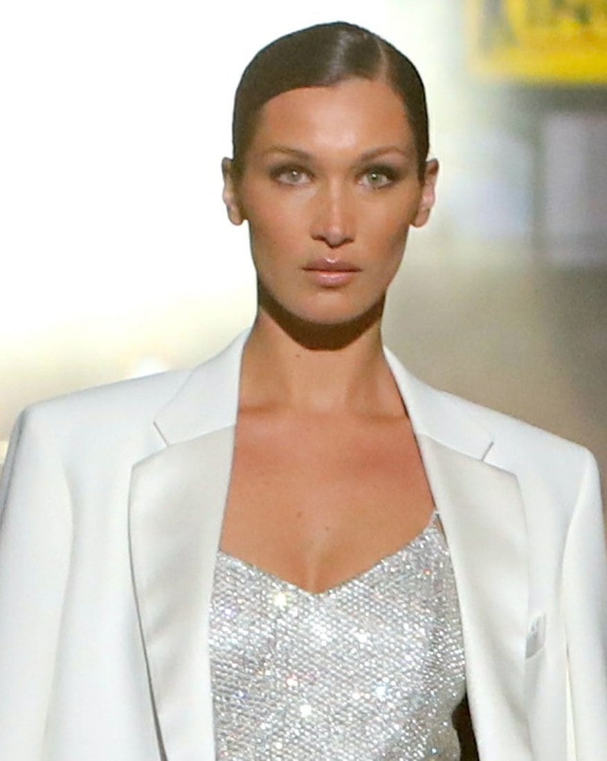 Bella Hadid's sleek center-parted ponytail and smoky eye makeup complemented the shimmering crystal-embellished mini dress and oversized white blazer