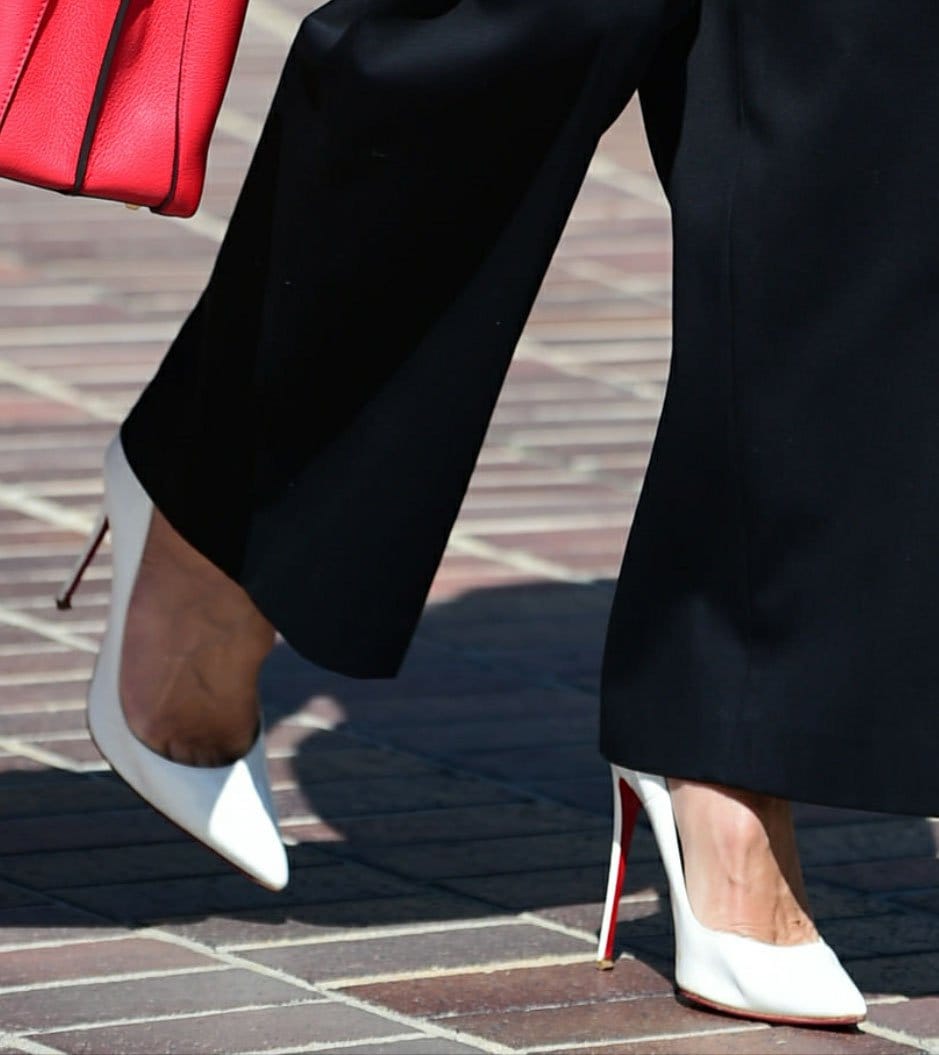 Heidi Klum steps out in white Christian Louboutin “So Kate” pumps, the sharply pointed toes and sky-high stiletto heels elongating her legs with signature red-sole polish