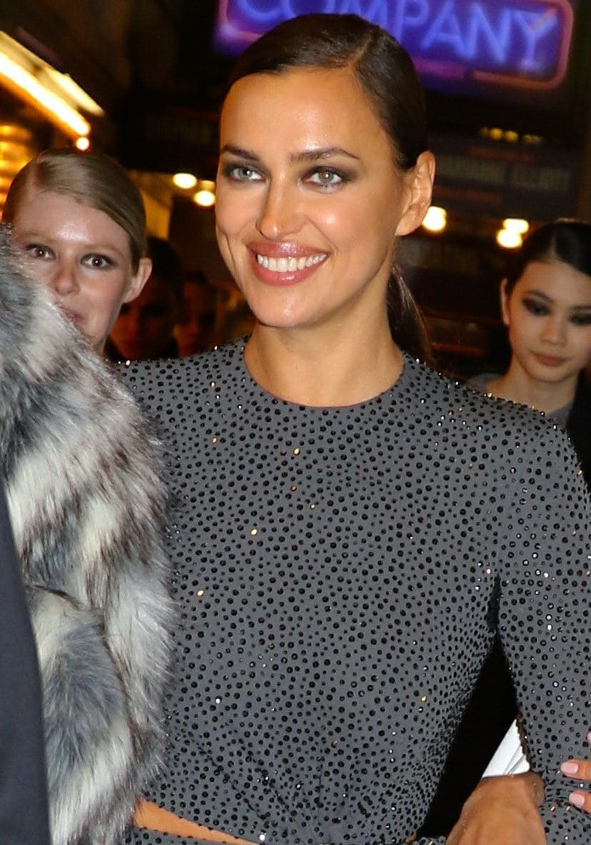 Irina Shayk completed her Michael Kors Fall/Winter 2021 runway look with sleek side-parted hair and smoky eye makeup