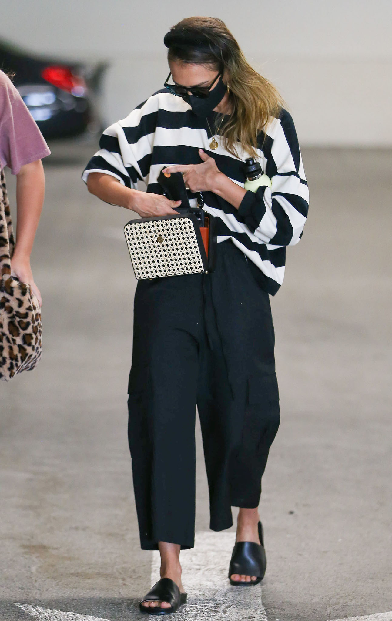 Jessica Alba goes for cool-mom style in a Rebecca Minkoff Rosie striped sweatshirt and wide-leg cargo pants