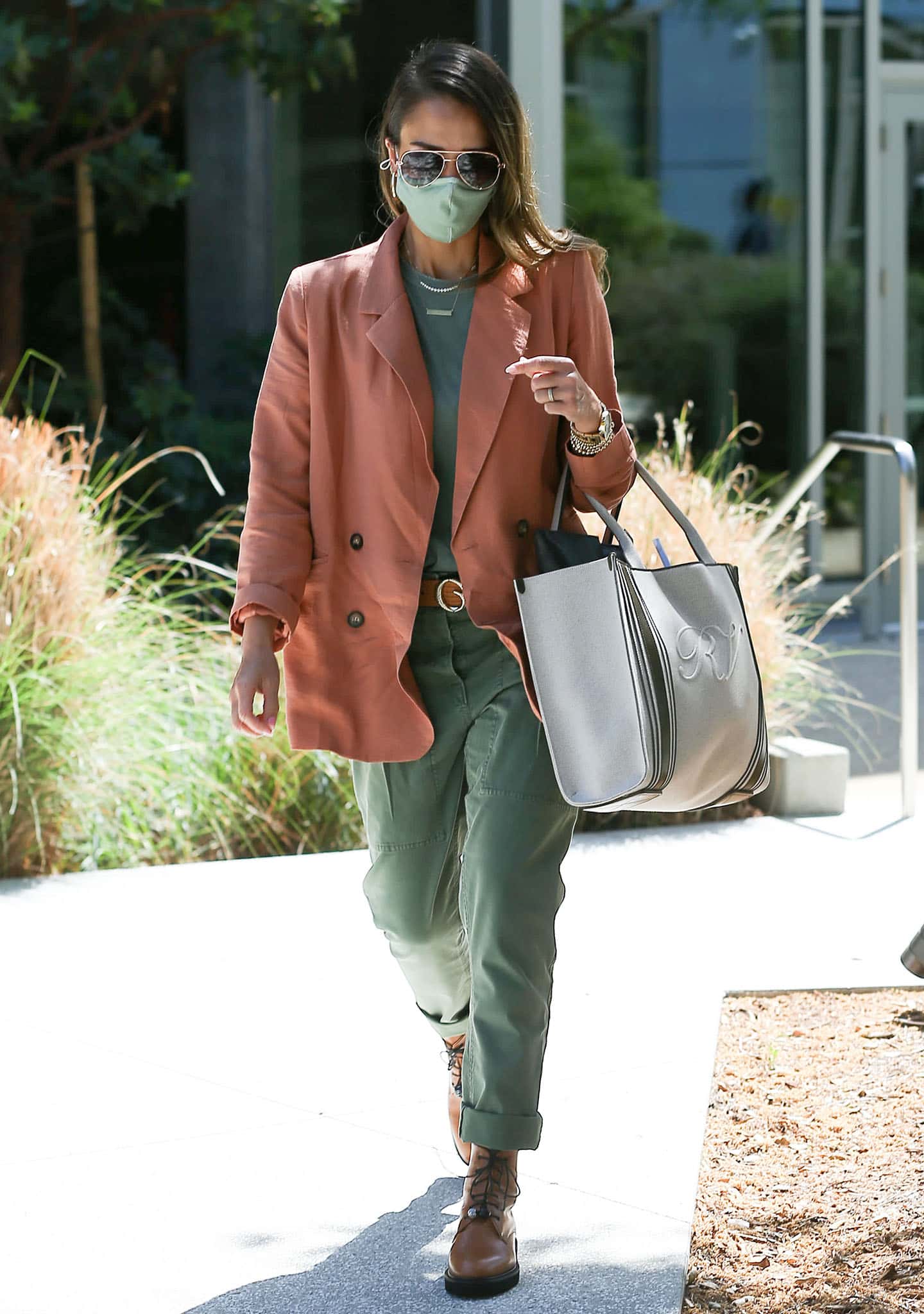 Jessica Alba balances soft tailoring with utilitarian edge in a peach double-breasted blazer and Dear Frances lace-up boots while arriving at The Honest Company headquarters in Los Angeles