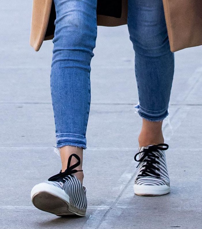A closer look at Nicky Hilton’s “Amanda” espadrille sneakers reveals their navy-and-white striped uppers, black ribbon laces, and chunky white soles