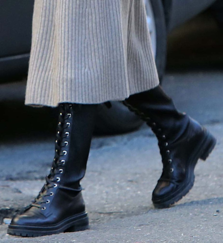 Close-up of Olivia Palermo's black Gianvito Rossi Martis knee-high lace-up combat boots with ribbed panels and lug soles
