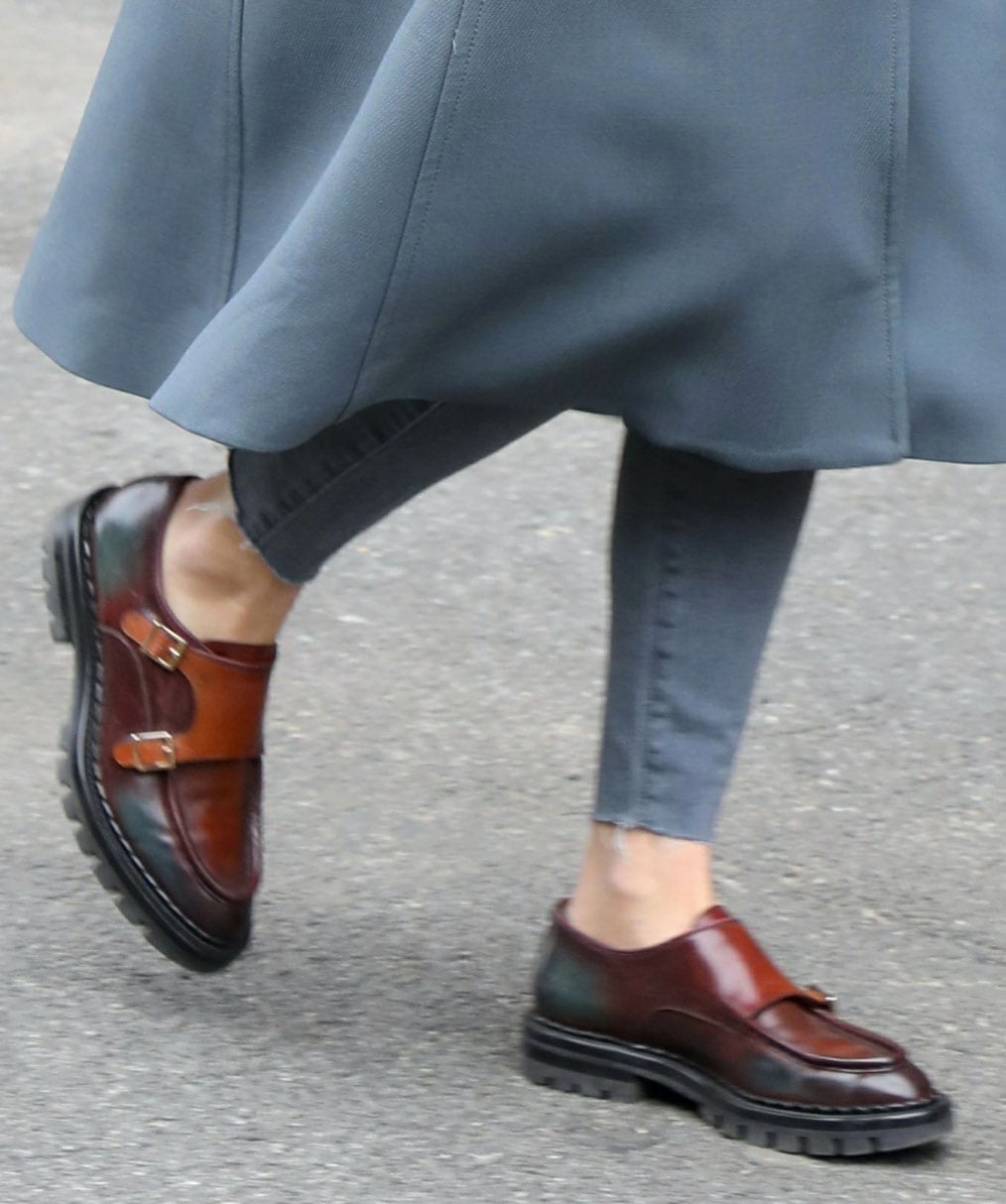 Close-up of Olivia Palermo's reddish-brown Santoni double monk-strap loafers with chunky black lug soles