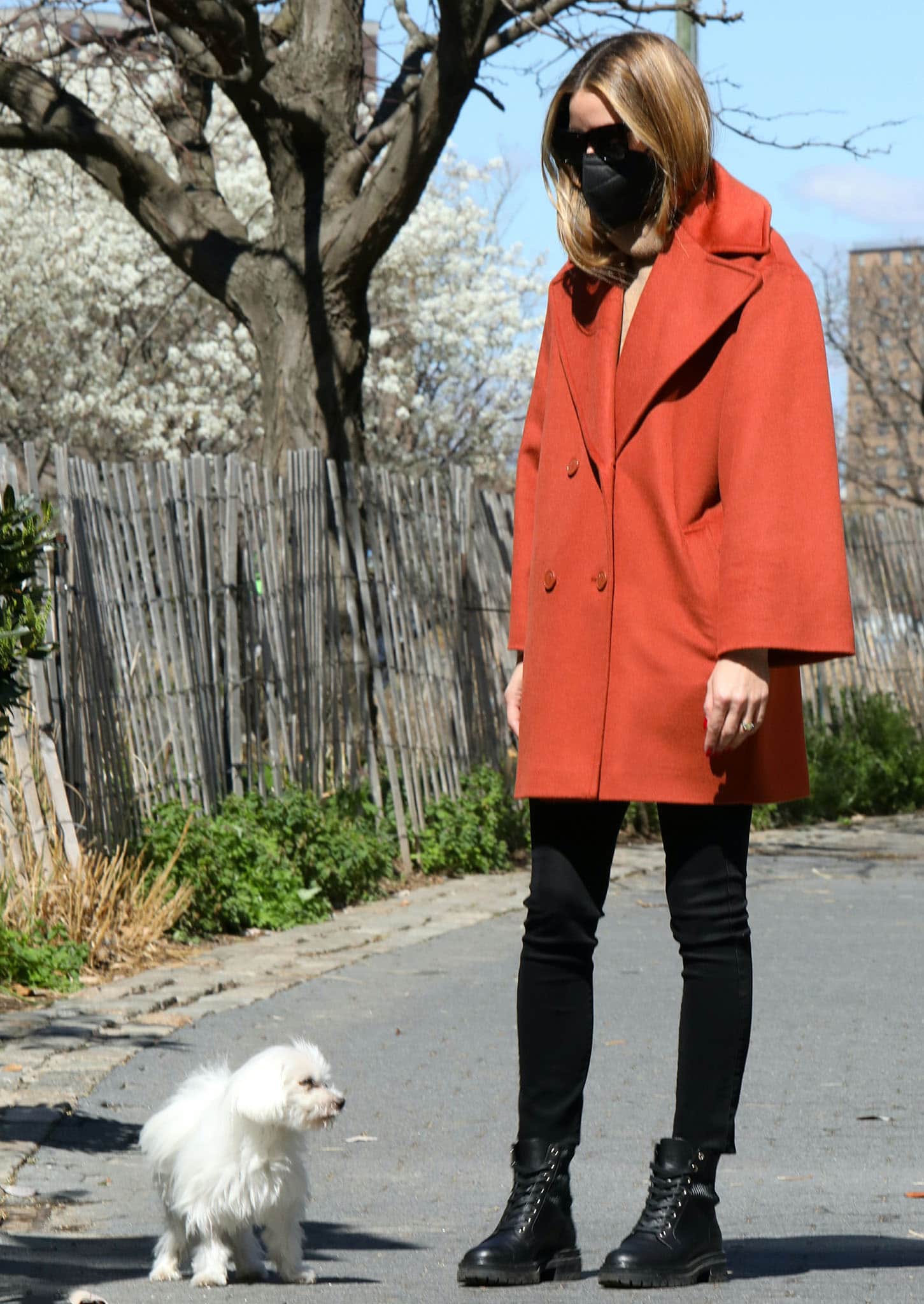 Olivia Palermo wears orange Max Co. coat with camel sweater and black leggings