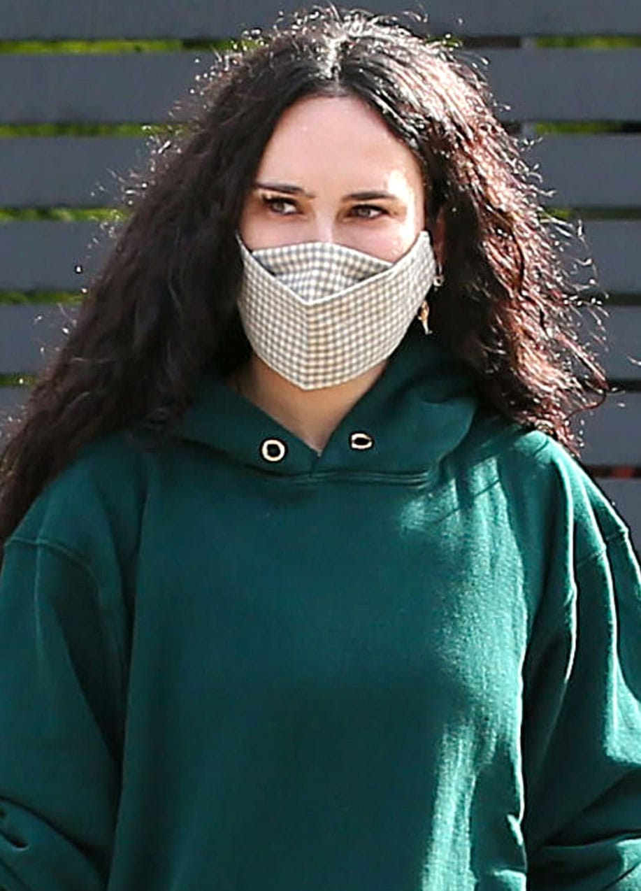 Rumer Willis wears her long, natural curly hair down and stays protected with a plaid face mask