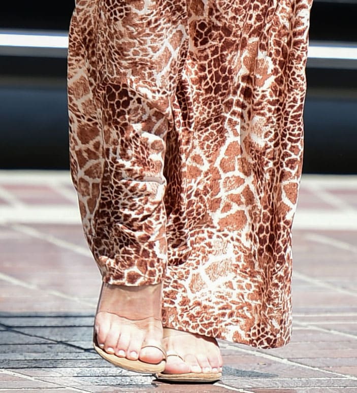 Sofia Vergara completes her giraffe-print look with minimalist toe-ring sandals featuring clear PVC straps and towering stiletto heels