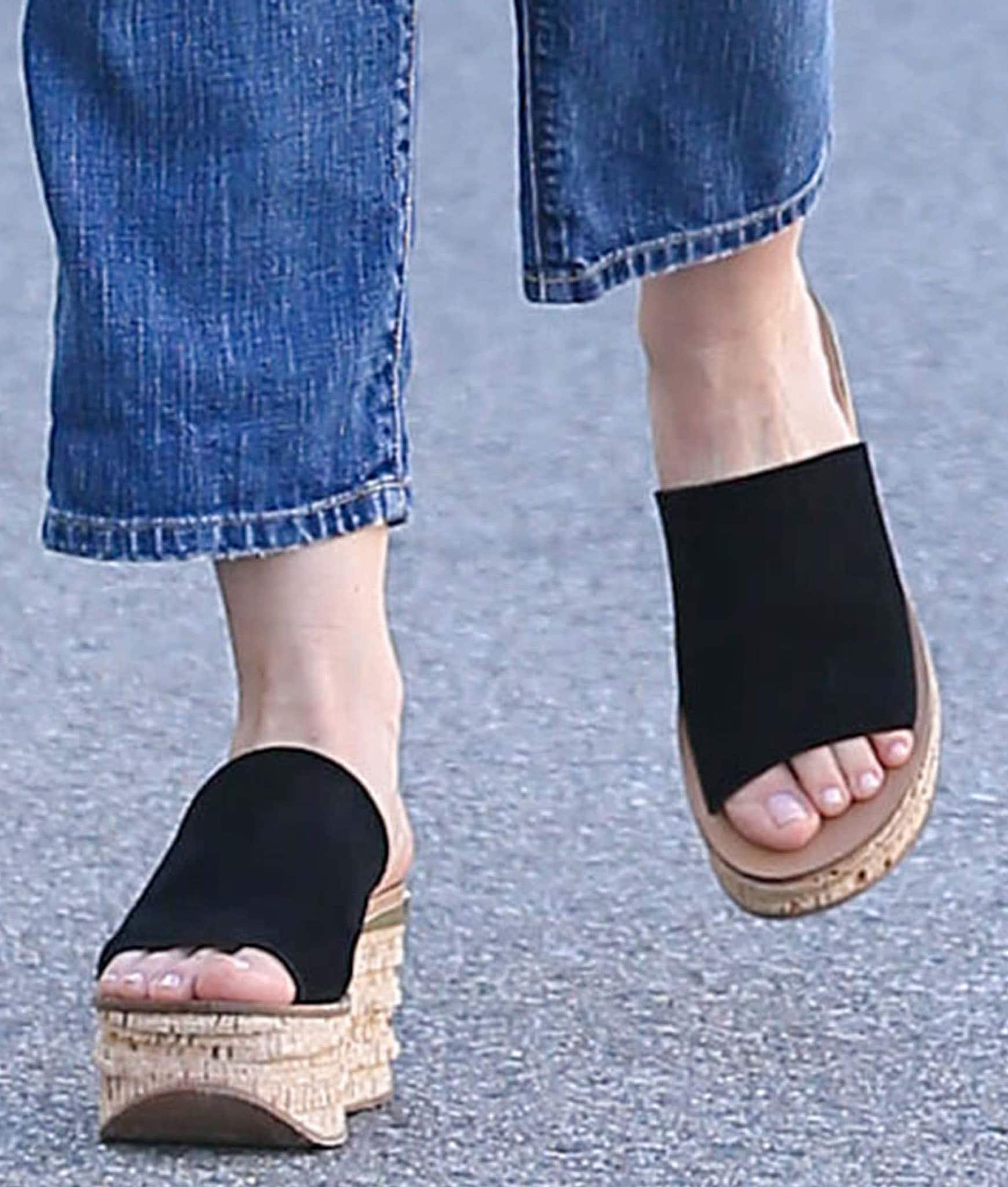 Sofia Vergara adds casual height to her denim look with black Chloé “Camille” slide sandals featuring cork wedge heels and wide suede straps