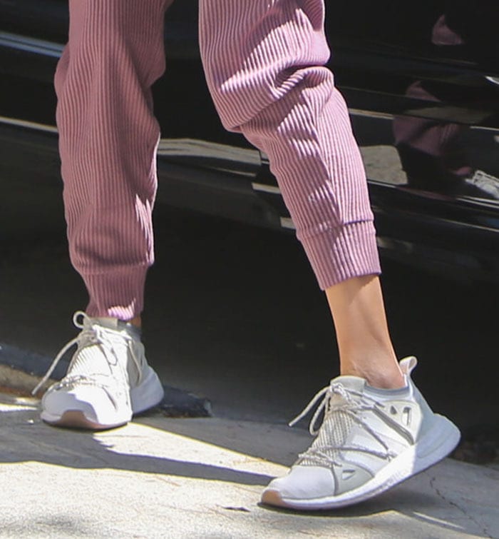 Alessandra Ambrosio grounds her sporty Pilates look with Adidas Arkyn sneakers, a sleek lifestyle runner featuring Boost cushioning and a distinctive crisscross lacing system