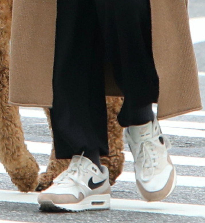 Blake Lively pairs her casual outfit with Nike Air Max 1 "Desert Sand" sneakers featuring sail mesh uppers, tan suede and leather overlays, grey Swooshes, visible Air cushioning, and gum rubber outsoles