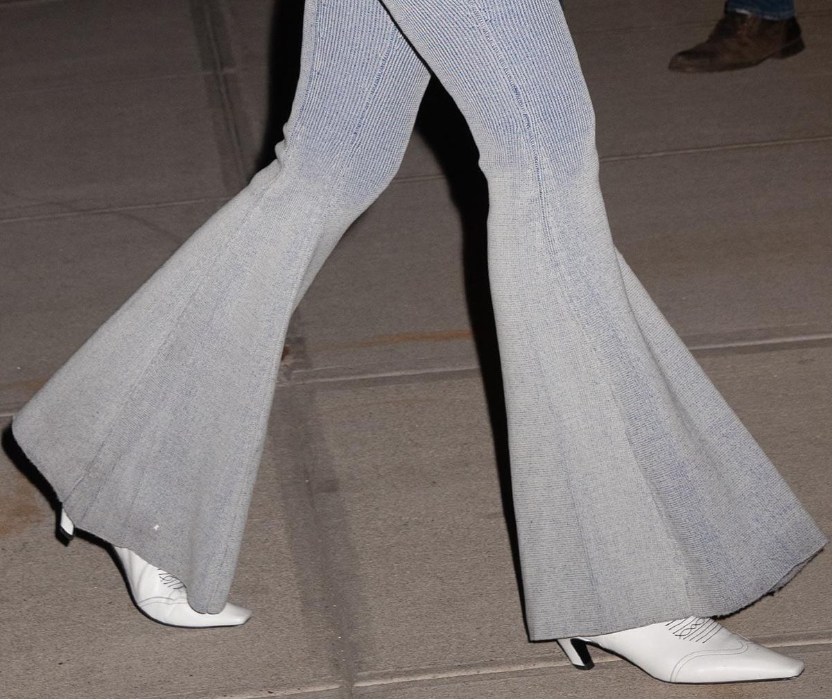Gigi’s sharply pointed Khaite Dallas boots add crisp Western structure beneath the flowing knit flares
