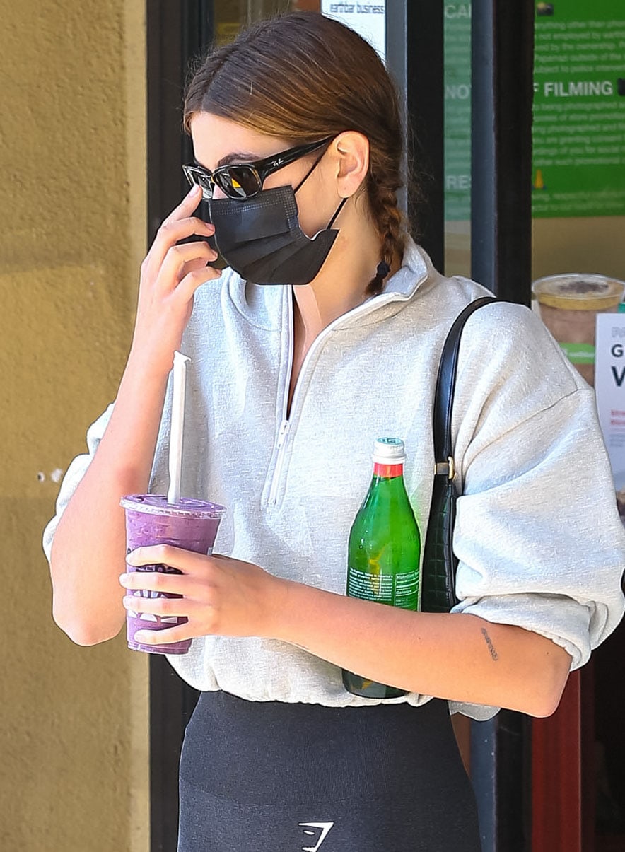 Kaia Gerber finishes her Pilates look with slim Ray-Ban sunglasses and a quilted Celine Ava bag, two accessories that became signatures of her model-off-duty wardrobe