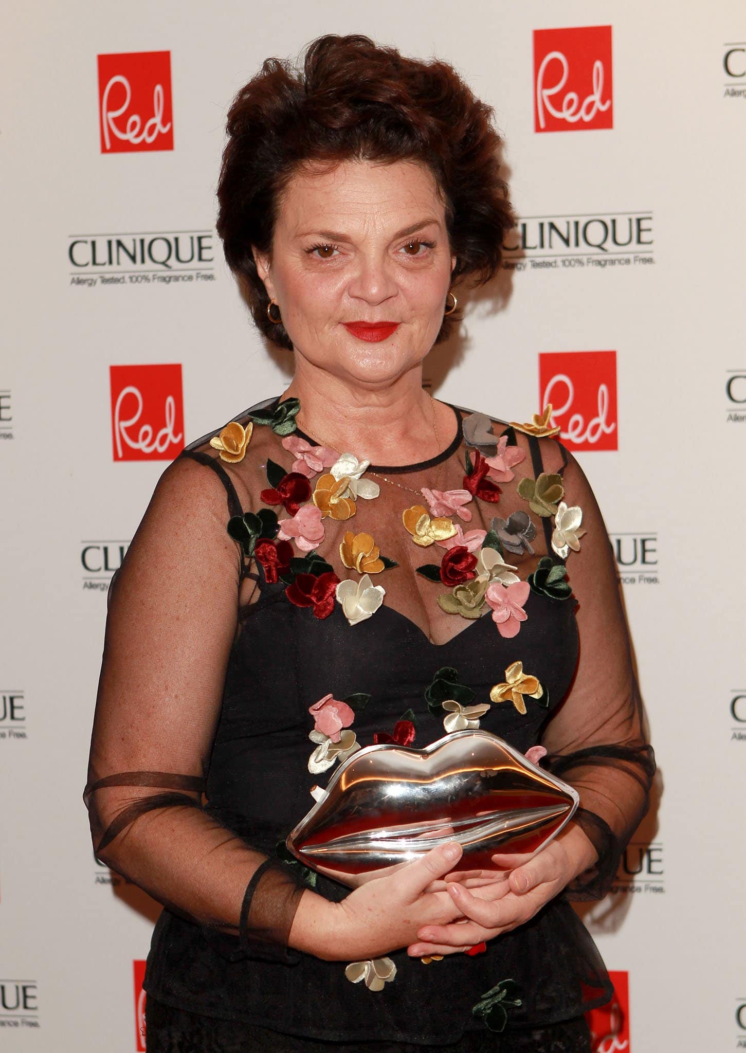 Lulu Guinness attends the Red Woman of the Year Awards on September 3, 2014, carrying her iconic metallic lips clutch—a playful signature of the brand’s witty, statement-making style