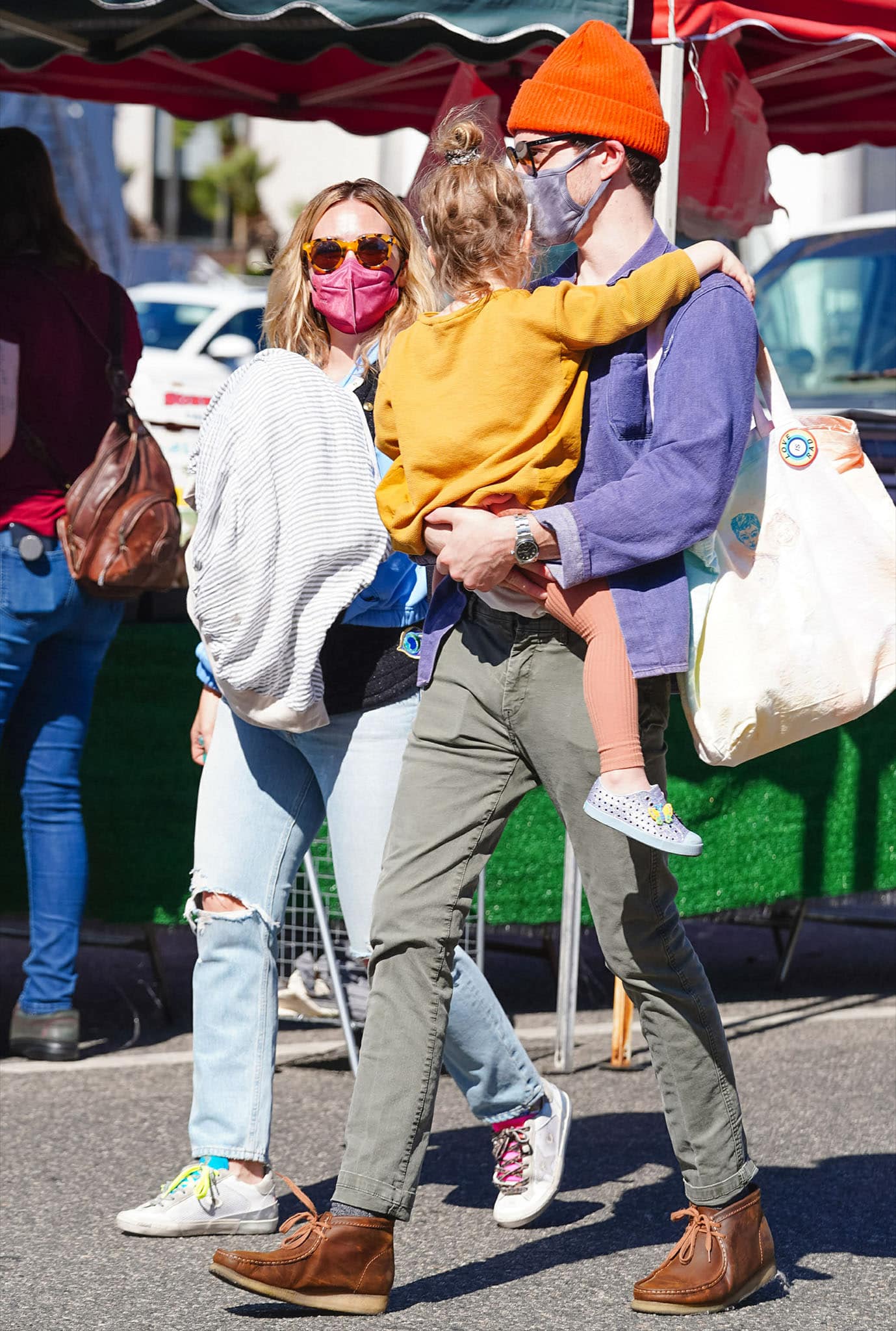 Hilary Duff walks alongside husband Matthew Koma and daughter Banks, with her collectible Golden Goose sneakers adding an unexpected flash of color to the relaxed family look