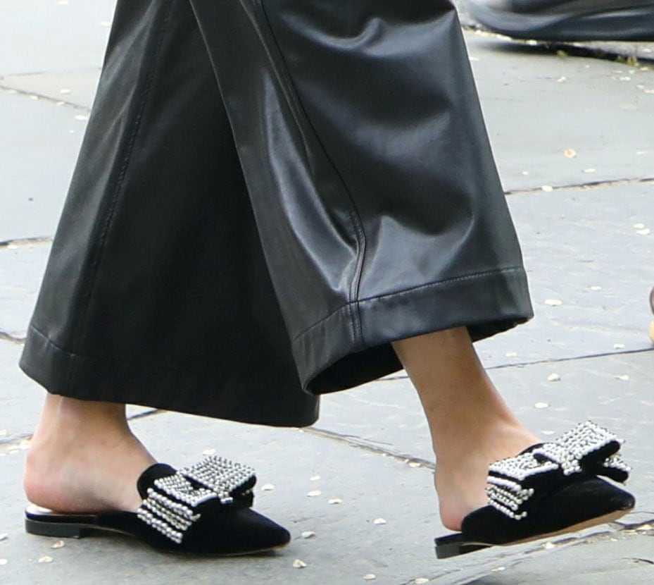 Olivia Palermo’s black velvet Alberta Ferretti mules feature pointed toes and oversized bows embellished with rows of pearls and beads