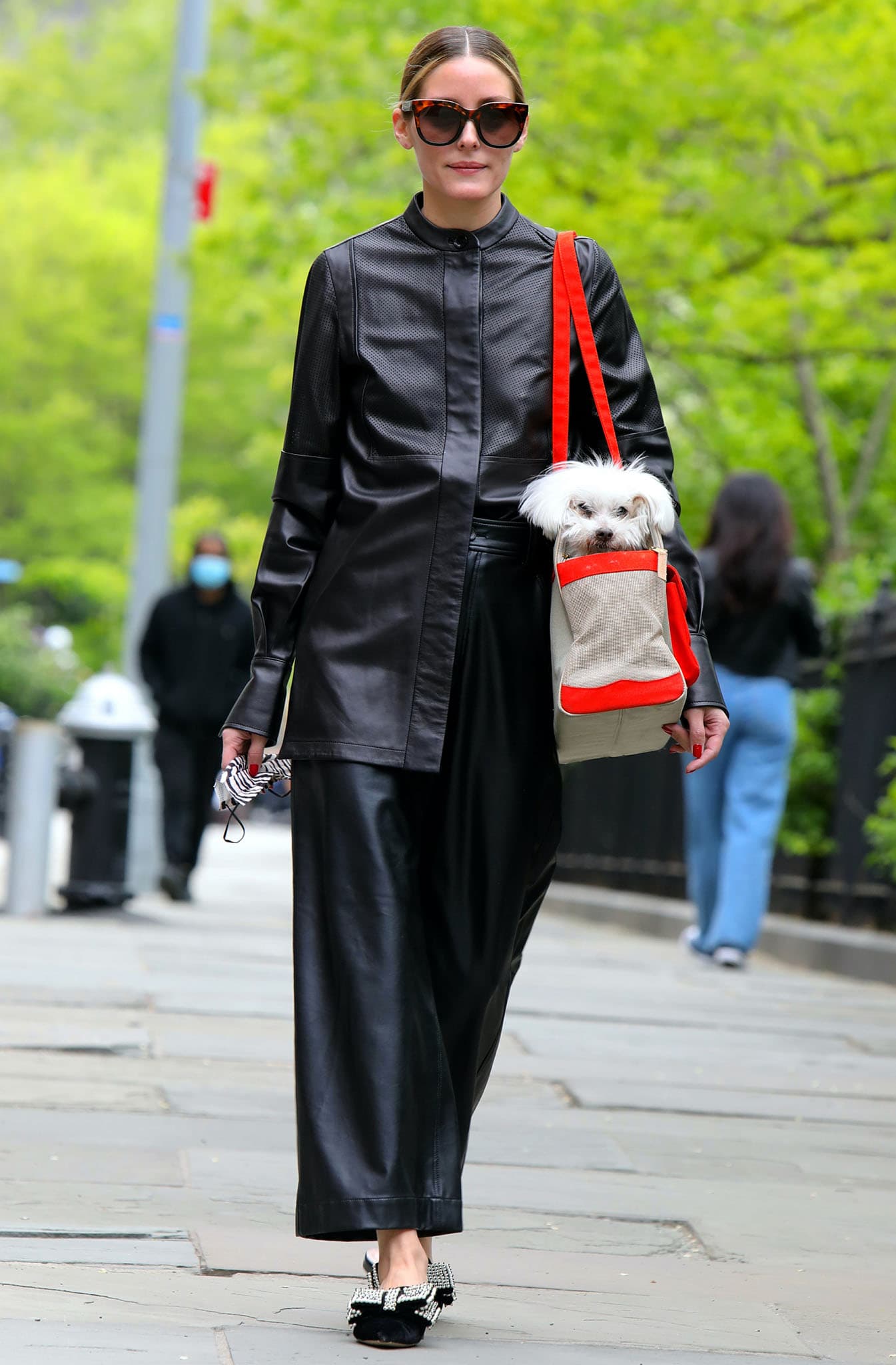 Olivia Palermo pairs a perforated black leather tunic with Tibi leather culottes and statement Alberta Ferretti mules