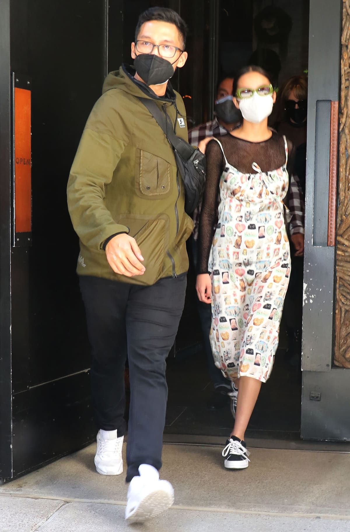 Olivia Rodrigo steps out for Saturday Night Live rehearsals in New York City on May 14, 2021, wearing a playful cat-print slip dress by Ashley Williams layered over a sheer black long-sleeve top, finished with classic black-and-white lace-up sneakers that add a casual, off-duty contrast to the quirky, statement-making look