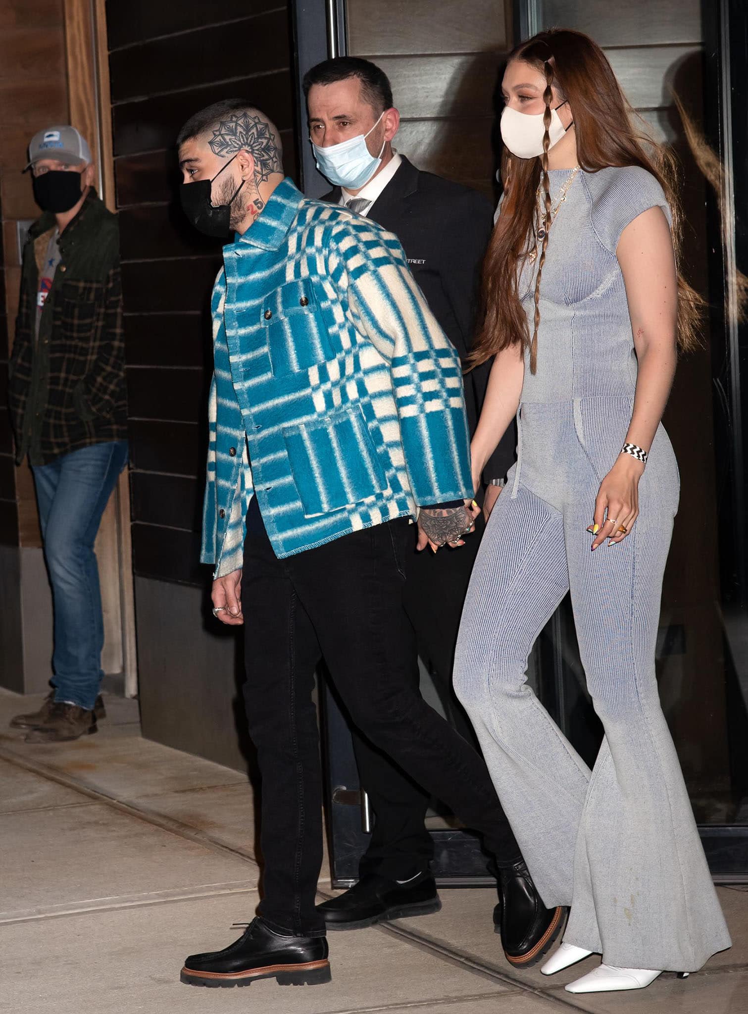 Hand in hand with Zayn Malik, Gigi lets her monochromatic knit look contrast with his bold turquoise plaid jacket and black lug-sole shoes