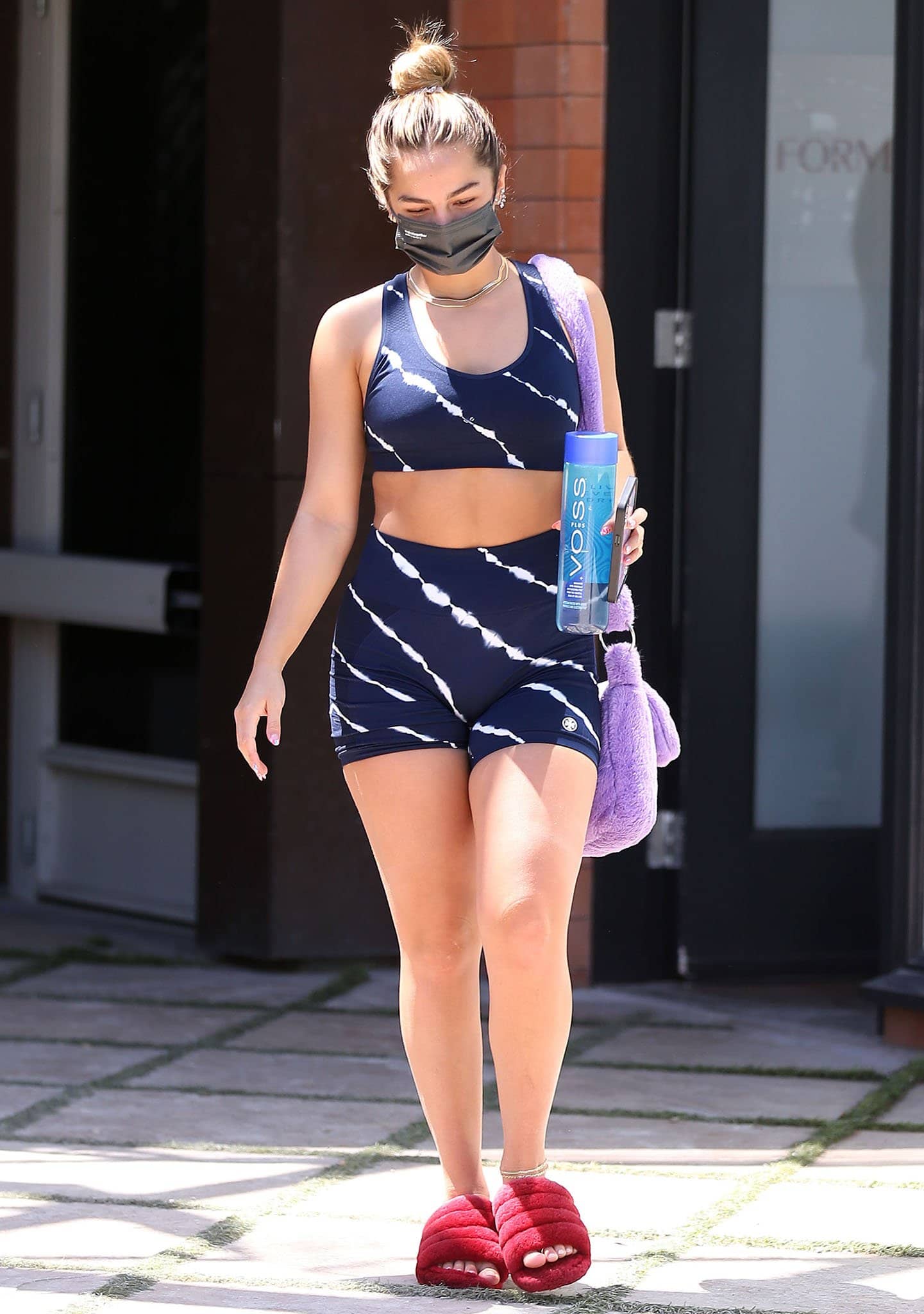 Addison Rae steps out in a coordinated Tory Sport tie-dye bra top and matching biker shorts, showing off her toned silhouette and laid-back confidence while leaving a Los Angeles workout on June 10, 2021