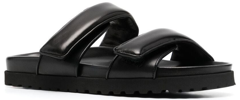 GIABORGHINI's padded double-strap slides combine smooth leather bands, open toes, and chunky rubber soles in a minimalist design that became synonymous with luxury comfort dressing in the early 2020s