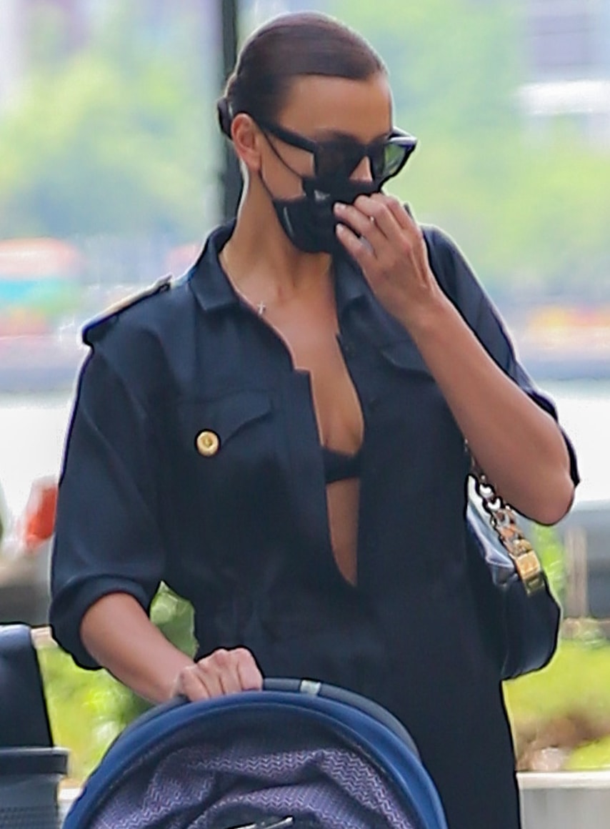 Irina Shayk keeps a low profile in Celine "Tilda" sunglasses and a Naked Cashmere x EvolveTogether face mask, adding a polished finish to her relaxed Burberry jumpsuit and sleek pulled-back hairstyle