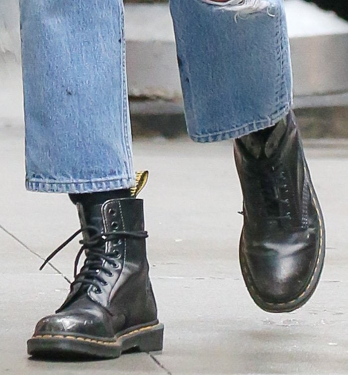 Irina Shayk grounds her vintage Britney Spears tee and distressed denim with classic Dr. Martens 1460 boots