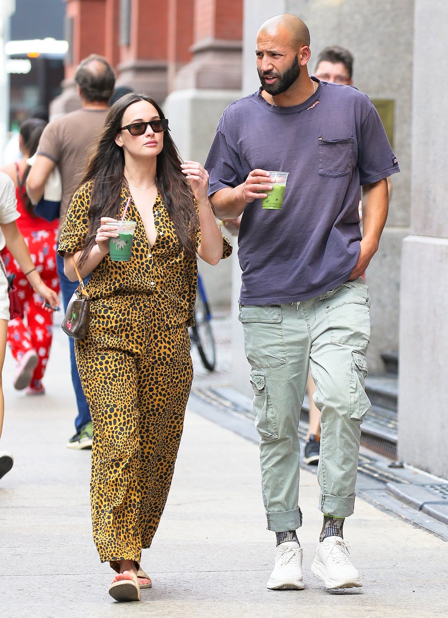 Kacey Musgraves styles her leopard-print co-ordinates with beige Freedom Moses "Moses" slides while grabbing green juice with writer Cole Schafer