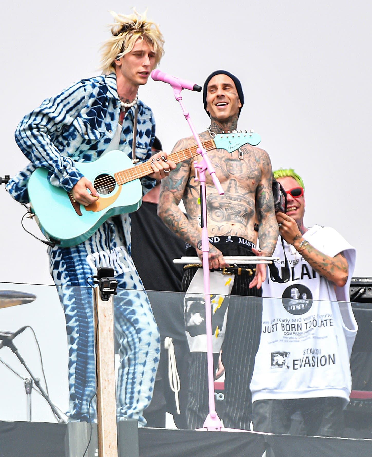 Machine Gun Kelly performs alongside drummer Travis Barker at his surprise rooftop concert in Venice Beach